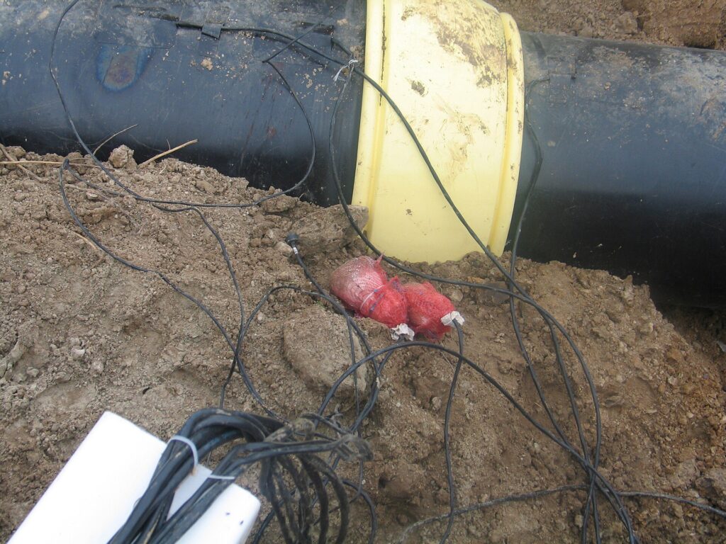 Test lead wires attached to a steel gas pipeline for cathodic protection monitoring
