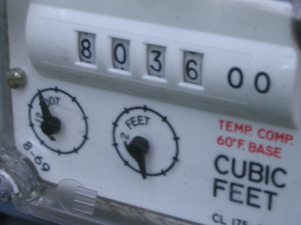 Close-up of a natural gas meter's cubic-feet index dials