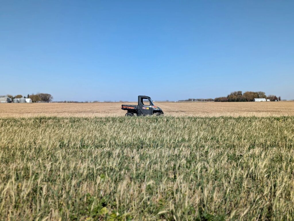A PinPoint utility vehicle crossing a Minnesota farm field during a natural gas leak survey