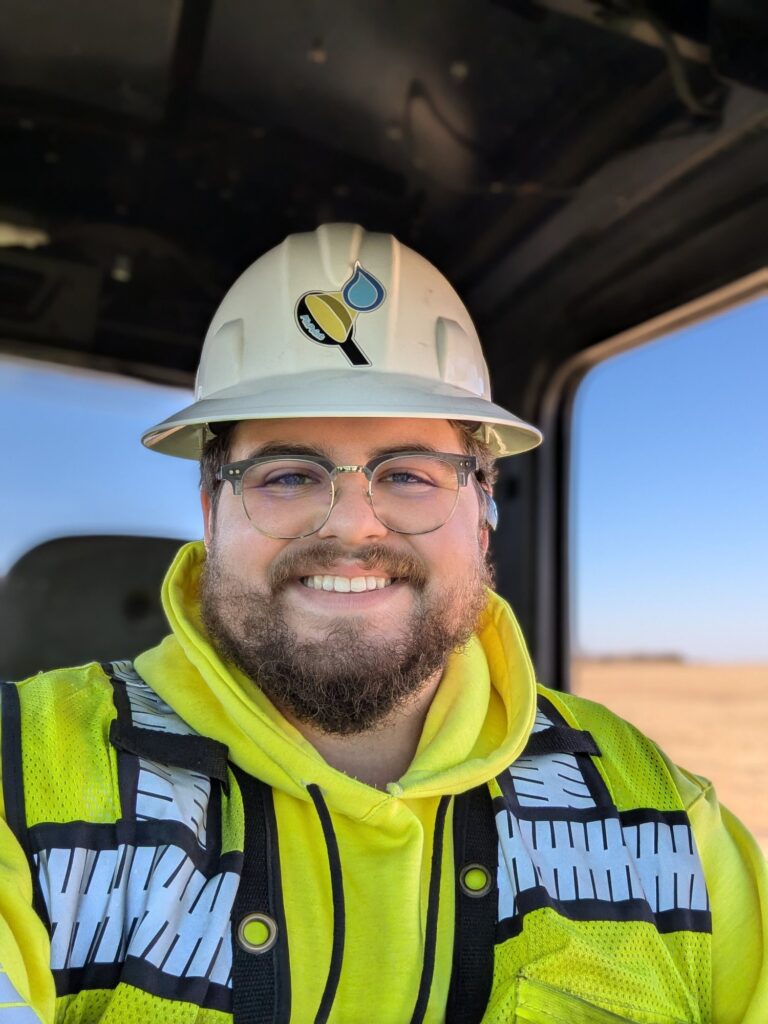 Lee Clyne, owner of PinPoint Natural Gas Services, smiling in a hard hat, safety glasses and high-visibility jacket
